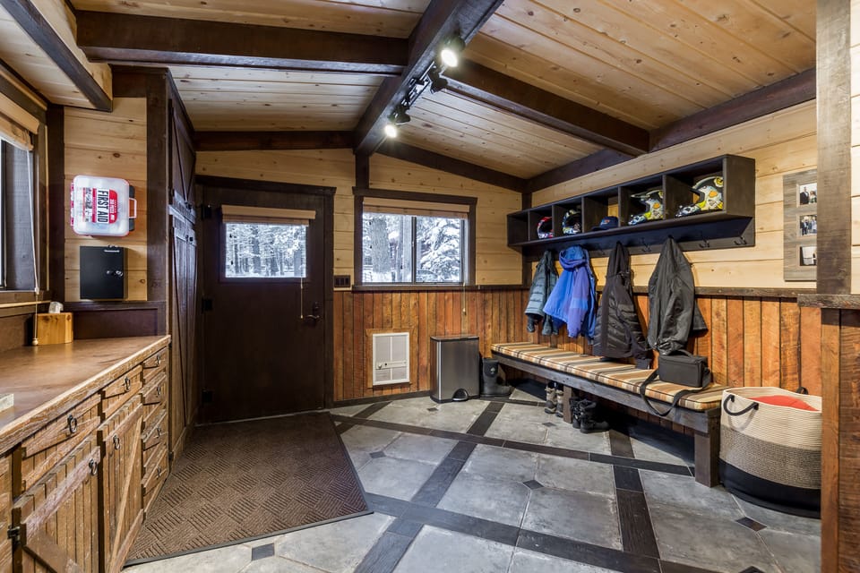Designed for mountain explorers, this spacious mudroom offers plenty of storage, cozy seating, and a warm welcome after a day in the mountains.