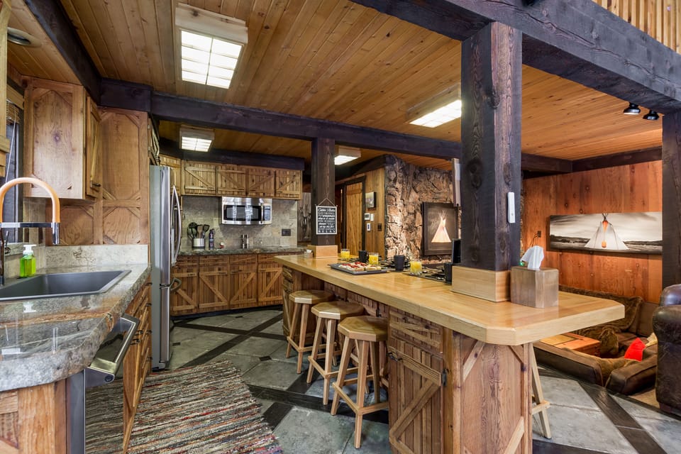 With handcrafted wood details, modern appliances, and a spacious bar, this kitchen is the heart of the home—perfect for cooking, entertaining, and creating memories.