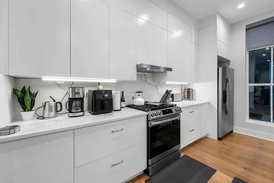 Beautifully design kitchen with all stainless steel appliances and amenities including: 

Rice cooker, air fryer, Blender, Instance Coffee Maker, Coffee grinder, Whisker, measuring cups, baking pan set, complete set of pots and pans, dishes, silverware, oven, assorted spicerack with 40+ spices, and more