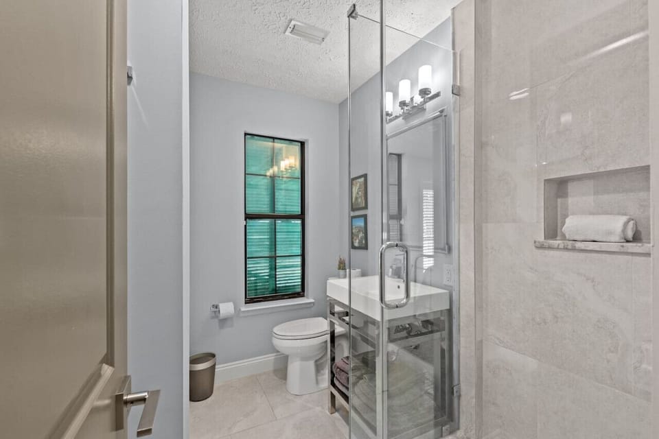 This marble shower, enclosed in glass, brings a touch of sophistication to your vacation.