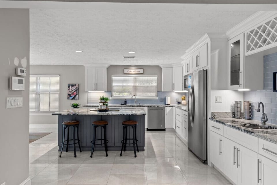 The kitchen is exceptionally spacious, offering extra bar stools and abundant natural light for guests to enjoy.