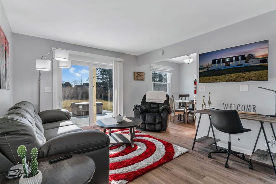Multifunctional living room space with direct access to the hot tub outside.