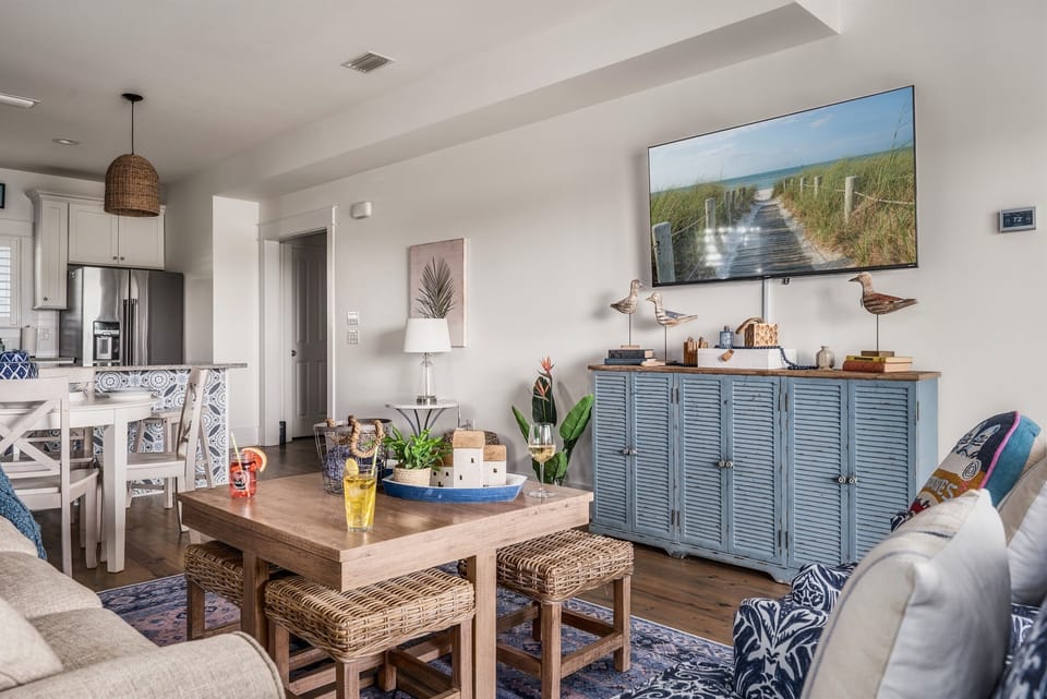 Kick back and relax in this cheerful coastal nook—complete with playful pillows, ocean-themed art, and all the comfy vibes your beach escape deserves!