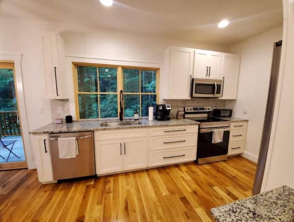 Full kitchen complete with everything you need. A gas grill is on the balcony.