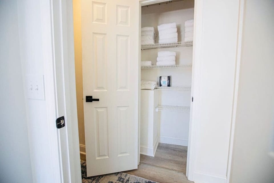 Fully stocked linen closet in the main floor hallway, ensuring a comfortable and well-prepared stay.