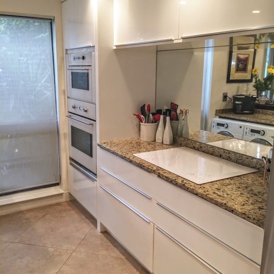Modern European kitchen with double ovens.