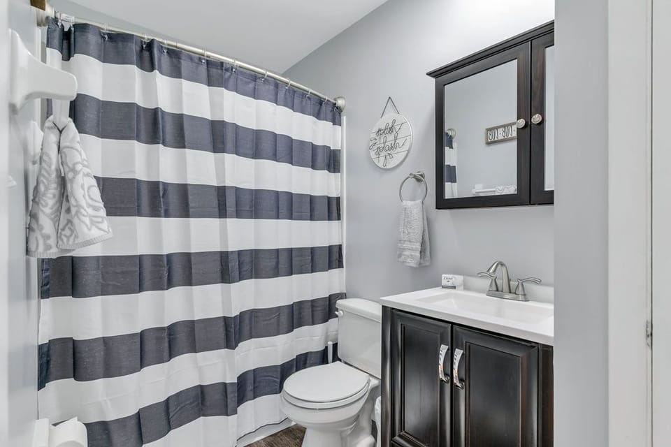 Bathroom features a combination tub/shower with extra storage in the vanity.  