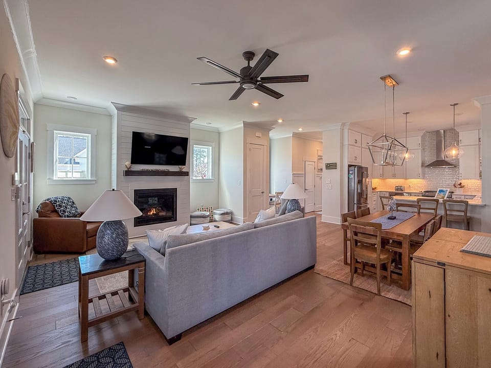 The living room has comfortable seating and a Smart TV.
