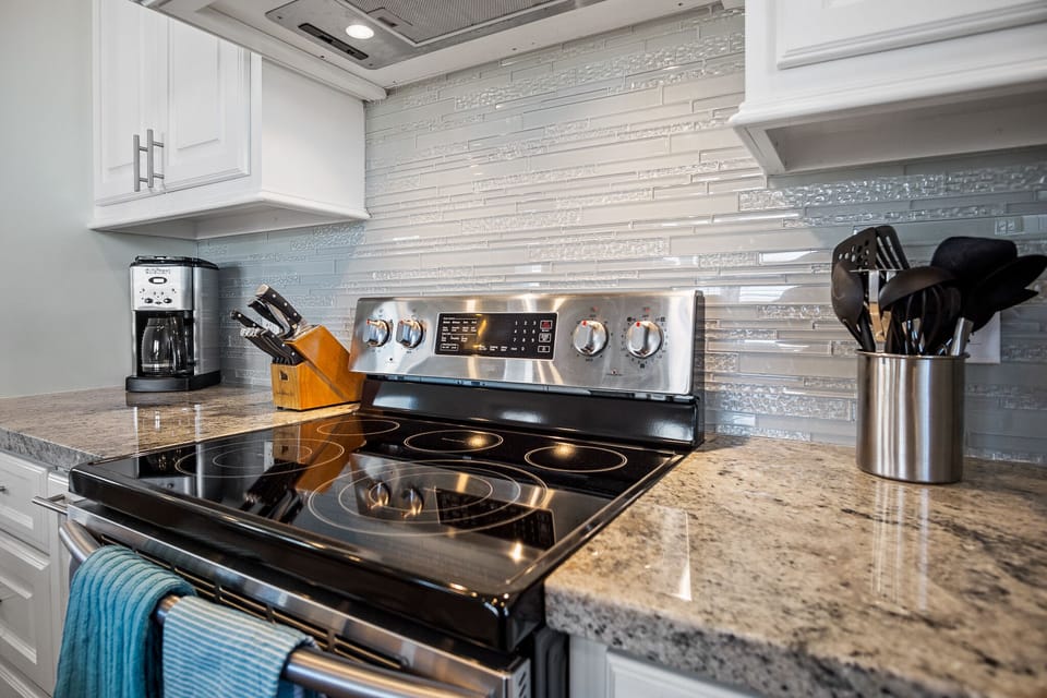 Pineapple Paradise Kitchen: Unleash your inner chef in this fully equipped kitchen, outfitted with stainless steel appliances, electric cooktop, ensuring every meal is prepared to perfection.