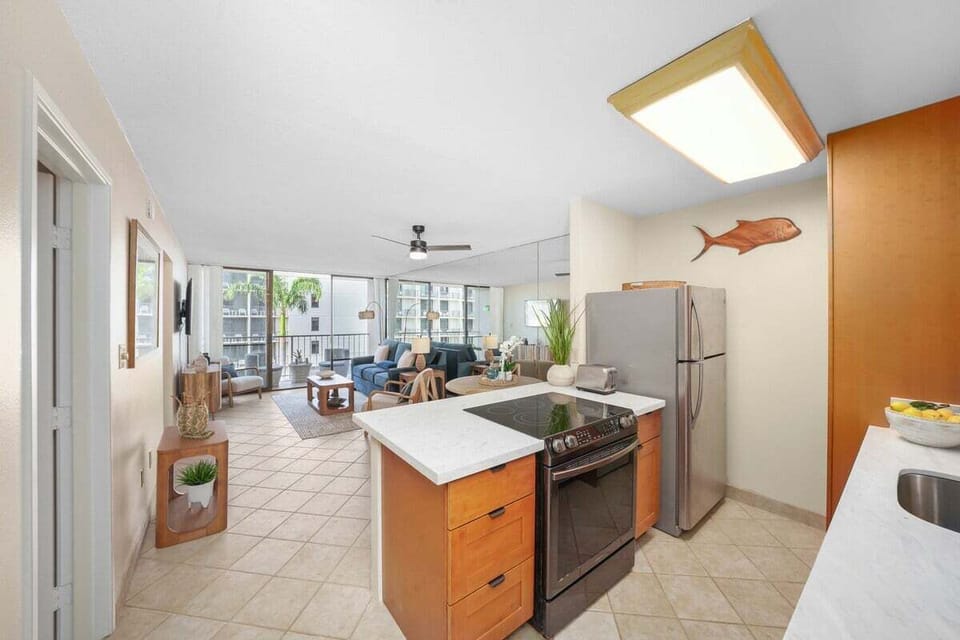 Open kitchen and living layout — central island, modern appliances, and seamless flow.