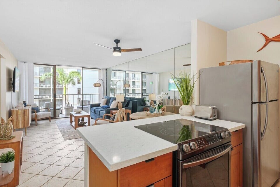 Open-plan layout with balcony access — tiled floors, glass doors, and seamless flow to kitchen.