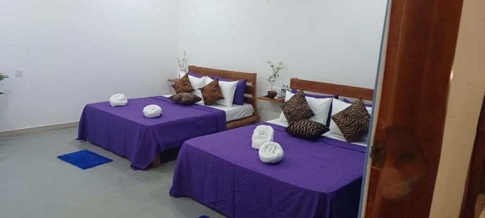 Deluxe Quadruple Room | Desk, iron/ironing board