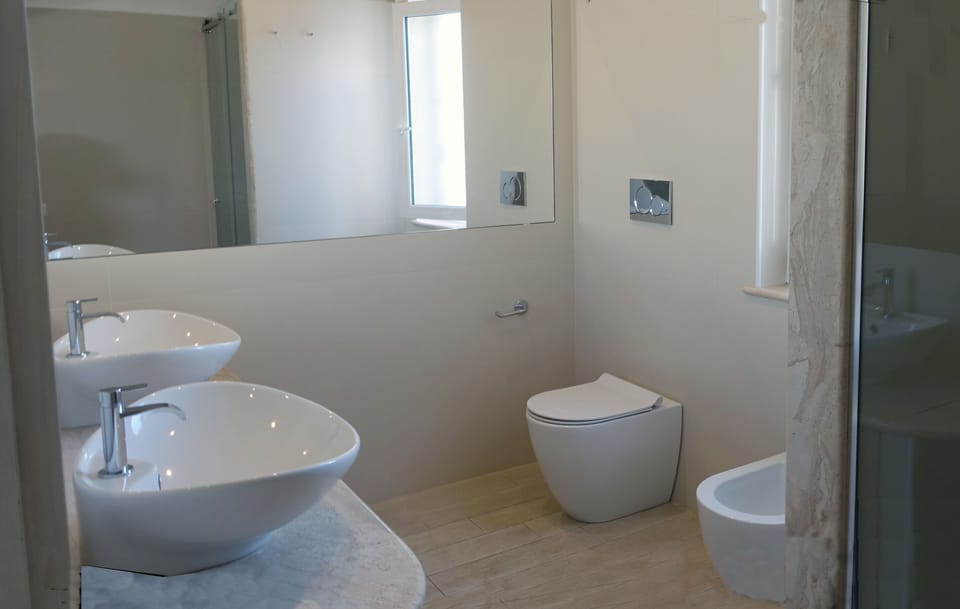 Deluxe Family Room | Bathroom | Shower, hair dryer, bathrobes, slippers