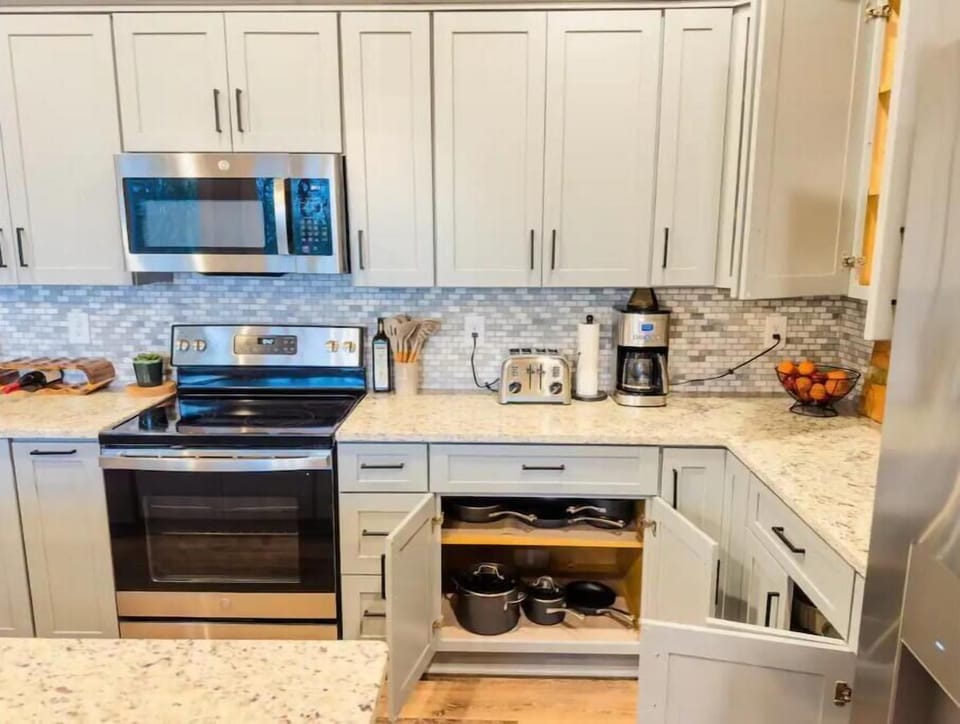 Fully stocked kitchen with coffee maker, blender, waffle maker, toaster