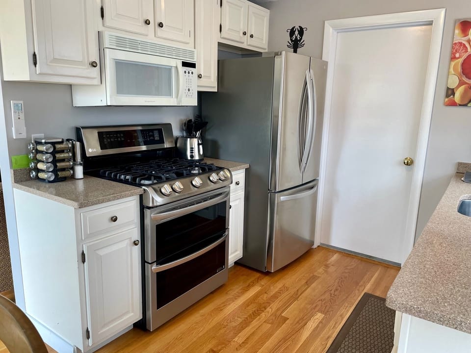Kitchen showing new gas range and stainless fridge