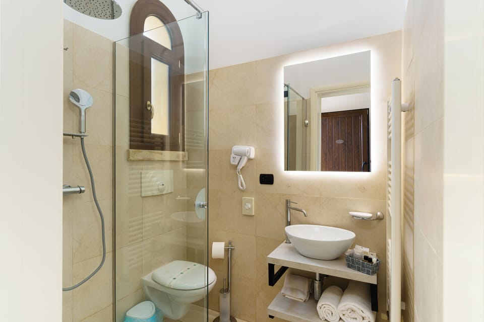 Shower, rainfall showerhead, hair dryer, towels