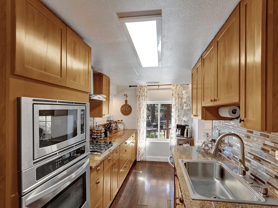 Beautiful custom cabinetry and modern appliances in a fully stocked, functional kitchen space.