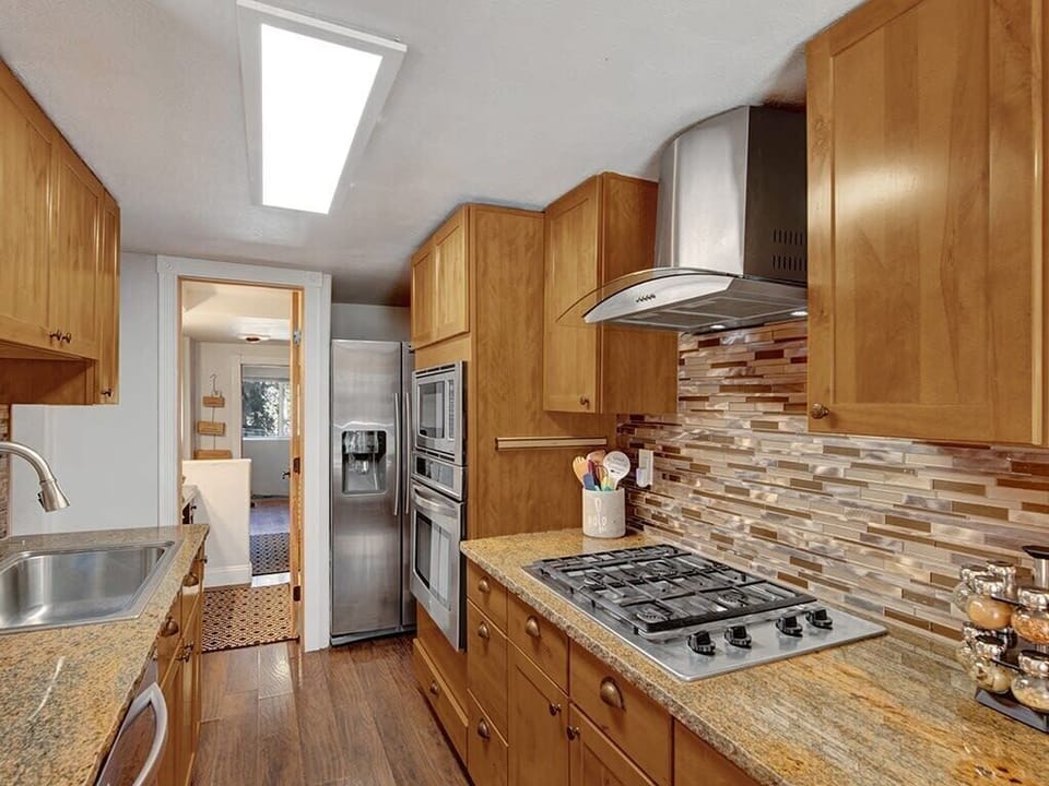 Fully equipped kitchen with warm wood finishes, ready for home-cooked meals.
