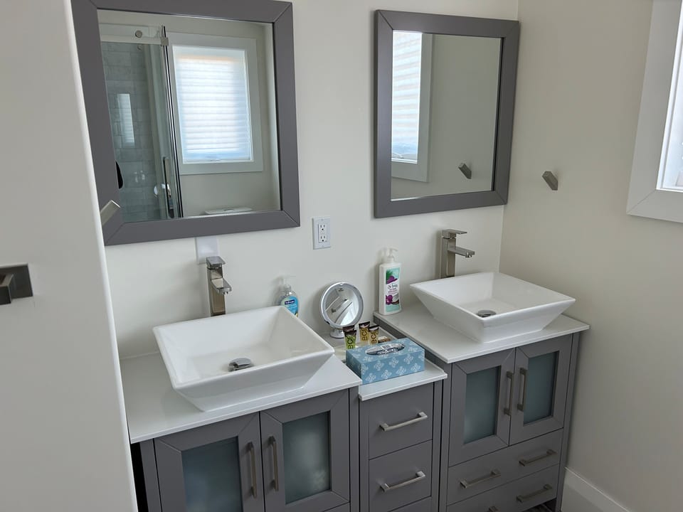 Twin bathroom sinks and supplied toiletries.