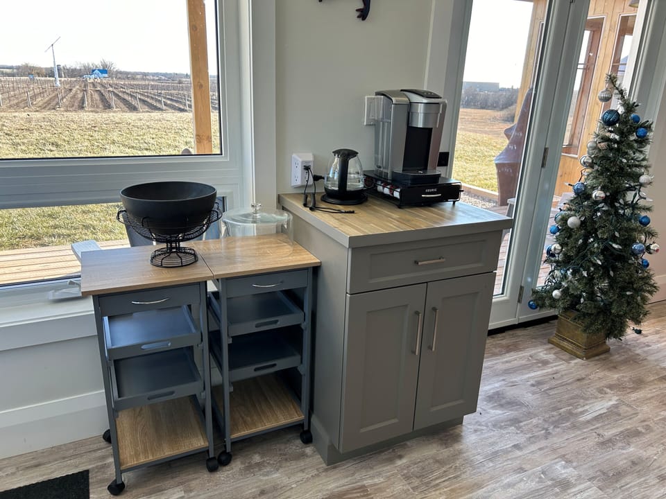Serving tables, Keurig & kettle, phone charging station, cupboard facing south