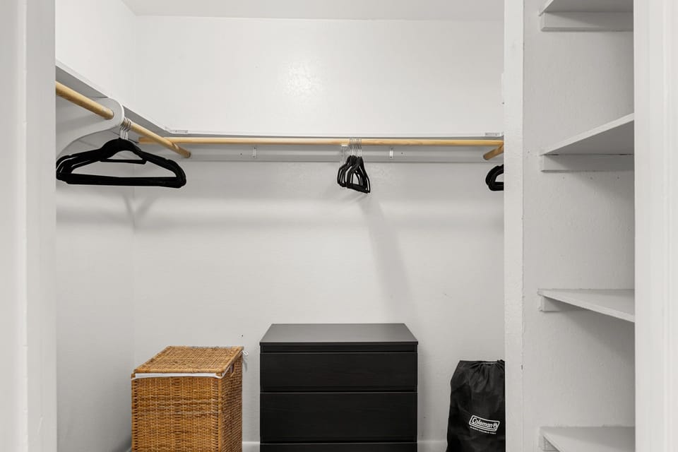 Primary walk-in closet with queen air mattress