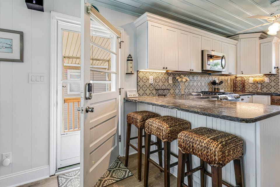 Enter to an open concept kitchen/dining/living area. 3 seats at the kitchen bar for snacks or games.