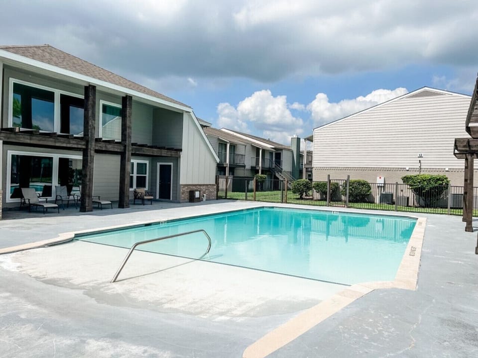 Enjoy a refreshing swim in the sparkling community pool surrounded by a peaceful courtyard setting.