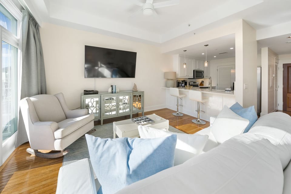Relax in your elegant living space with plush seating, flat-screen TV, and open-concept kitchen—perfect for unwinding after exploring the city.