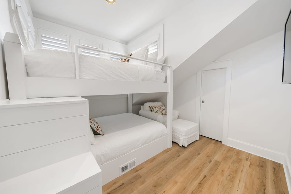 Cozy bunk beds create the perfect retreat where your family can rest comfortably in this bright, welcoming space.