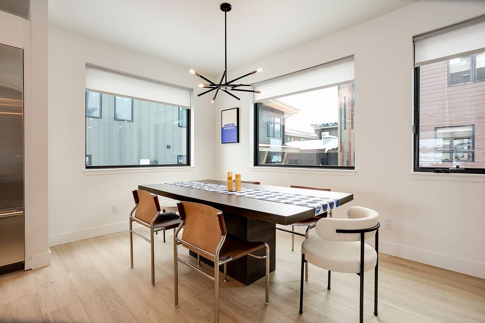 Gather around this stylish dining table where natural light streams through large windows, creating the perfect setting for memorable meals together.