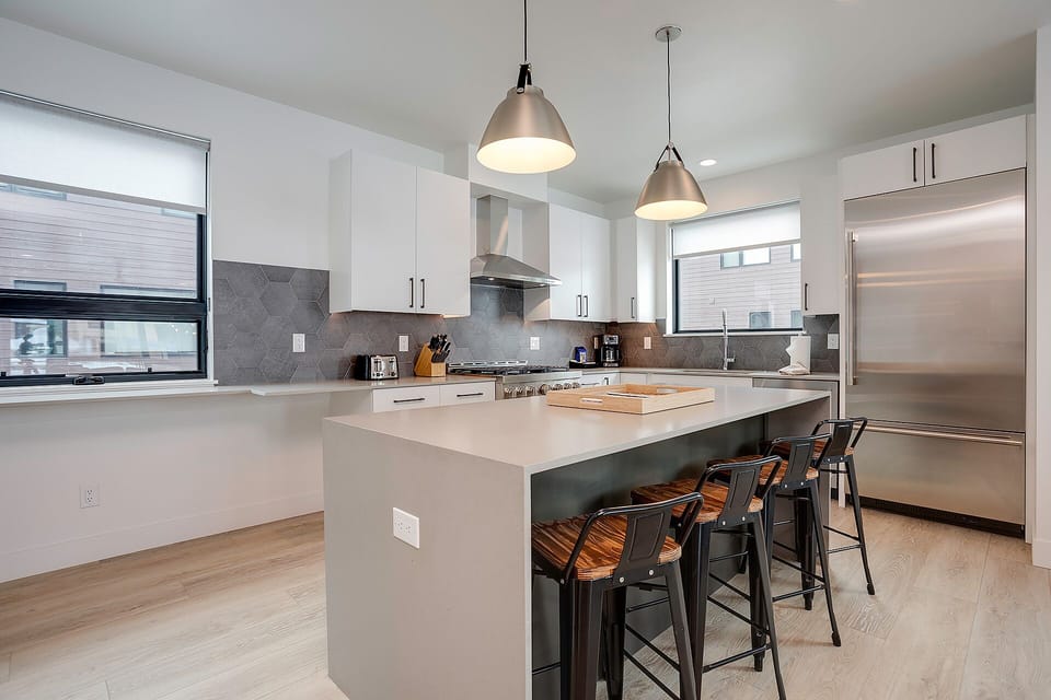 Cook your favorite meals in this sleek modern kitchen with stainless steel appliances and a spacious island for gathering.