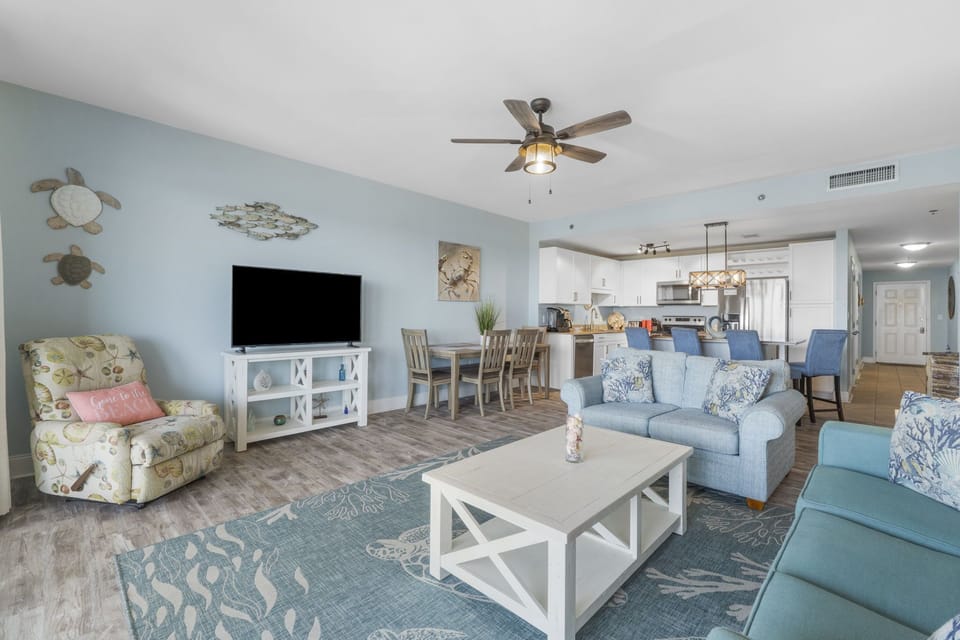 Open-concept living area with coastal decor and comfortable seating.