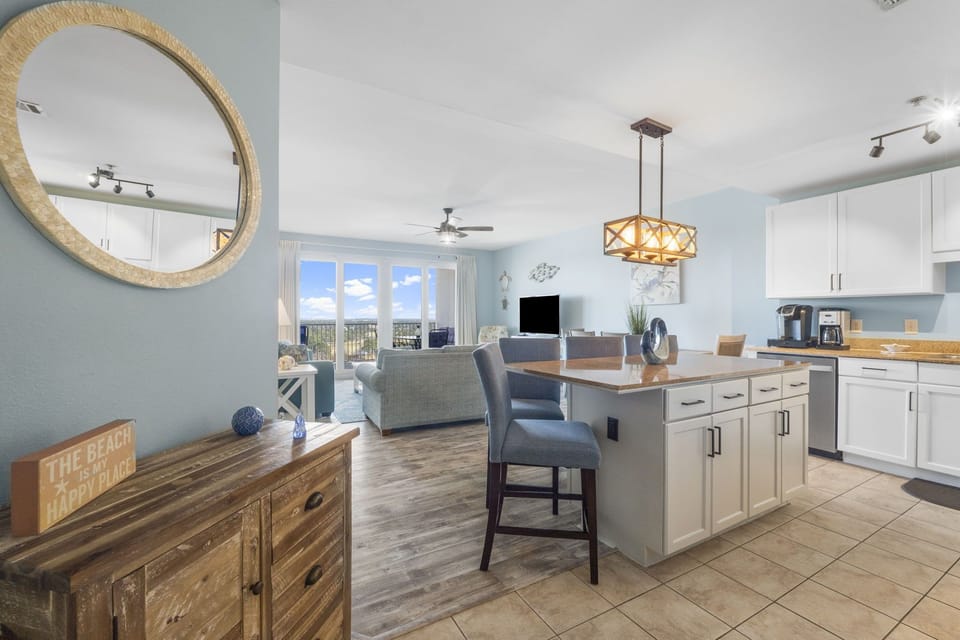 open-concept kitchen and living area with coastal decor and natural light