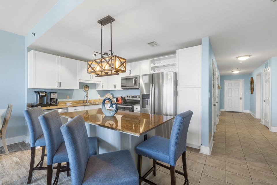 Modern kitchen with stainless steel appliances and a spacious island with seating.