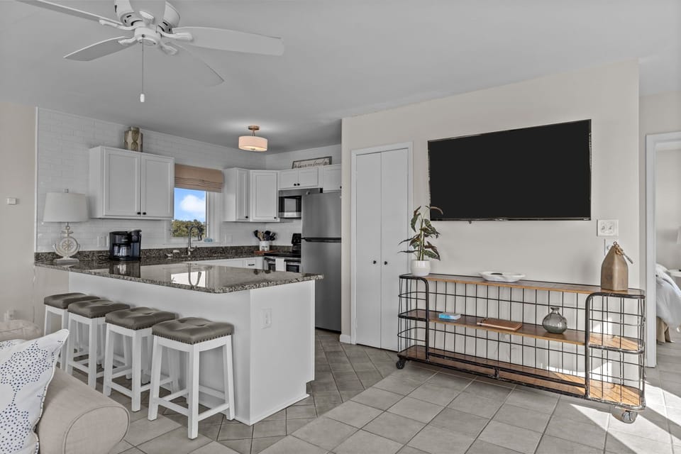 Relax in your modern open-concept space with a fully equipped kitchen, granite counters, and comfortable seating for cooking and entertainment.