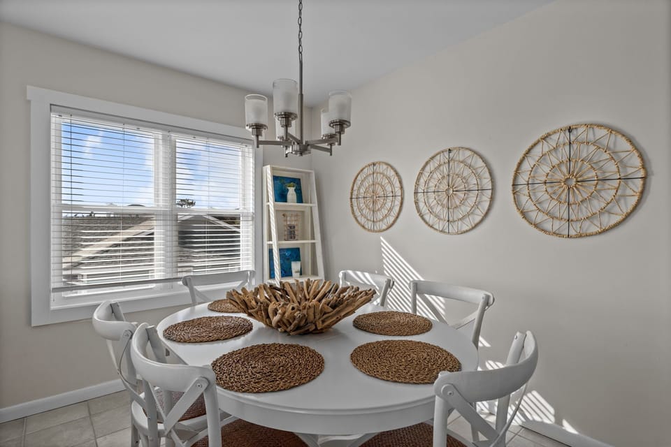 Gather around your bright dining table for memorable meals, with coastal charm and natural light streaming through the windows.
