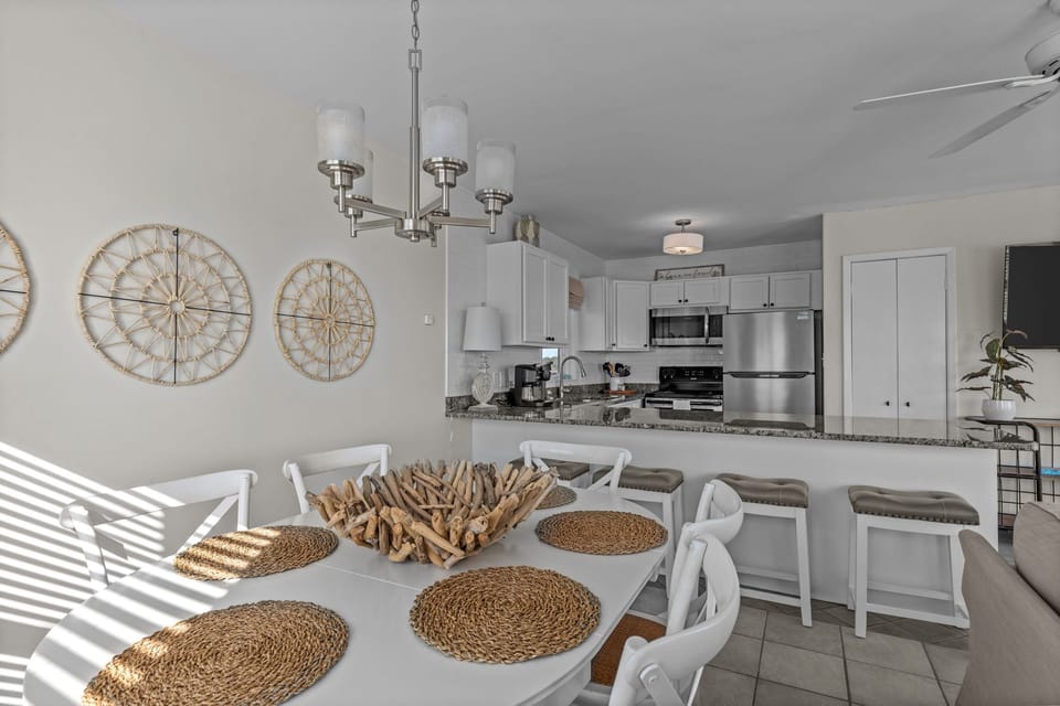 Gather around this bright dining space where coastal charm meets modern comfort, perfect for sharing memorable meals together.