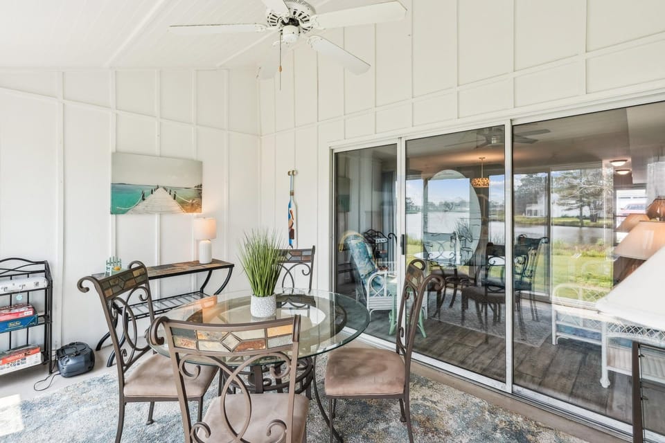 Step outside onto your private screened patio and dine with a peaceful waterfront view just beyond. It's the perfect spot for morning coffee or a relaxed evening meal.