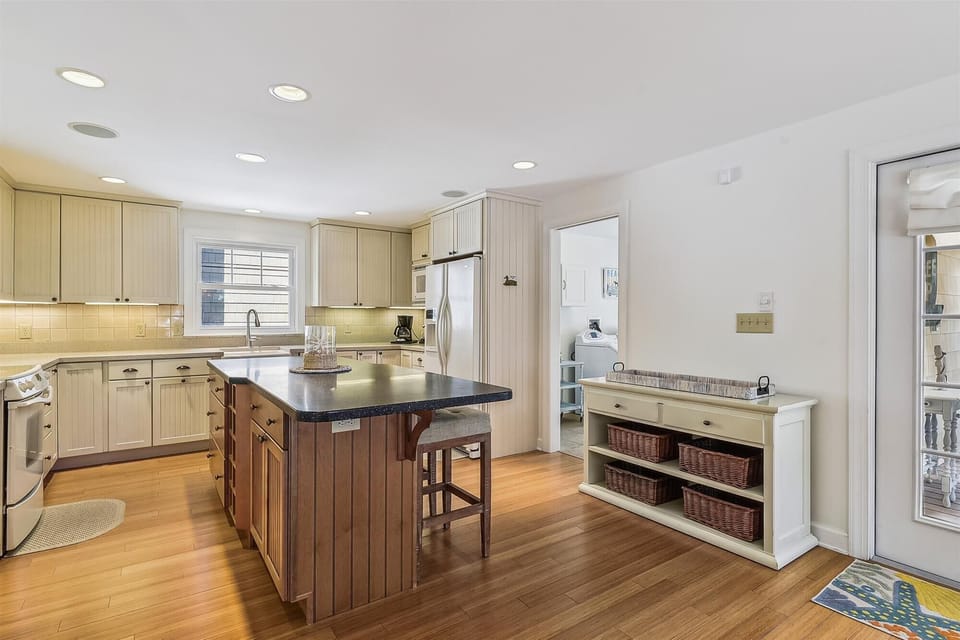 Picture yourself preparing meals in this spacious kitchen with gleaming countertops, modern appliances, and an inviting island where you can sip your morning coffee.