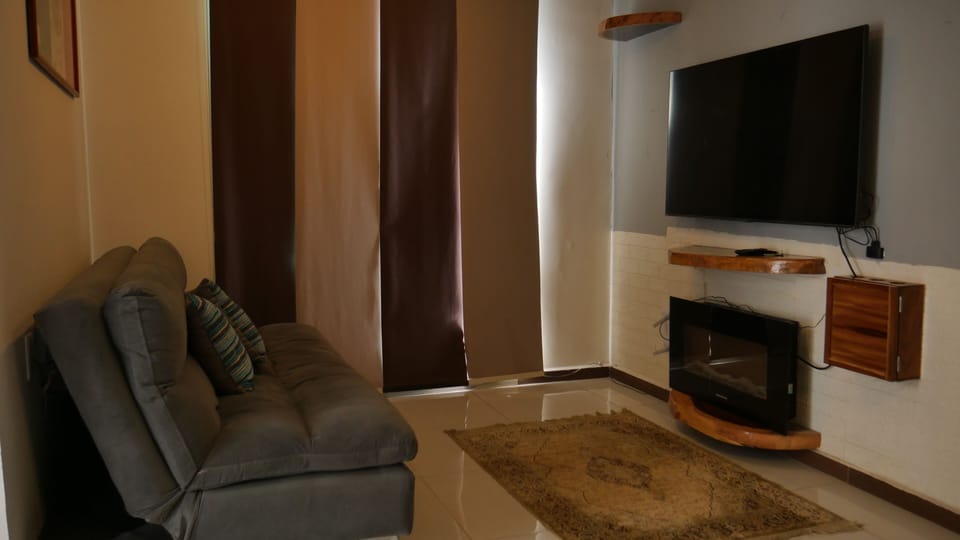 Executive Apartment | Living room | 42-inch Smart TV with cable channels, Netflix, iPod dock