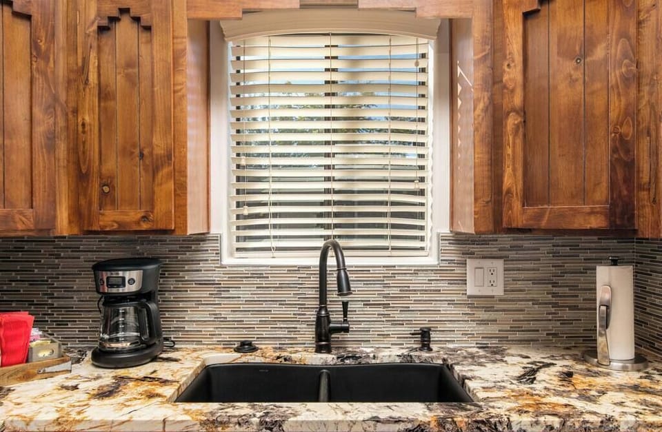 Bold and beautiful: Our kitchen boasts a striking black sink and artistic countertops, where style meets functionality