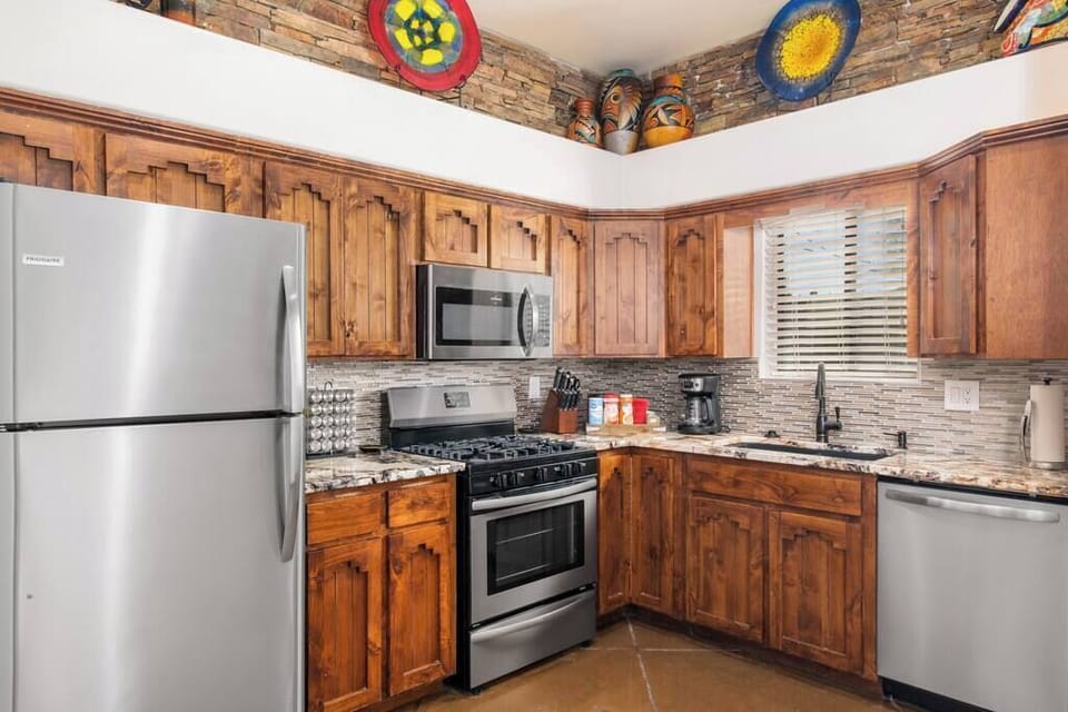 Where warmth meets modernity - our kitchen combines a rich wood theme with sleek stainless steel appliances for a harmonious culinary haven