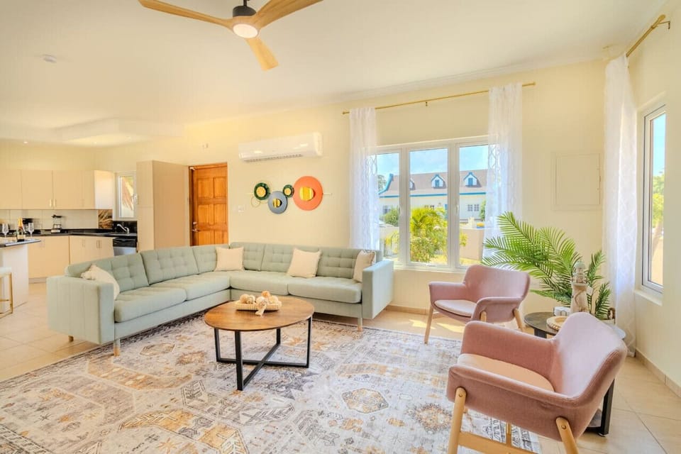 Indulge in comfort and entertainment in Opal Breeze`s spacious living room, complete with a large TV. With plush seating and stylish decor, this is not just a room; it`s a sanctuary for relaxation and shared moments.