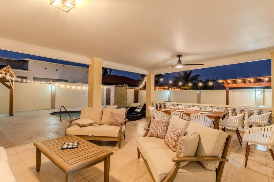 Embrace the enchanting ambiance of the night at Opal Breeze`s outdoor seating area, where soft lighting and plush furnishings create an inviting haven under the stars