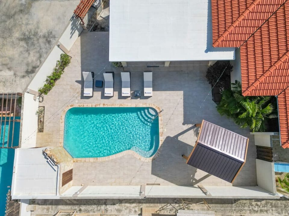 Revel in the grandeur of Opal Breeze pool retreat. An expanse of relaxation and luxury, where the cool waters invite you to unwind, and the abundance of lounge chairs ensures every moment is bathed in comfort.
