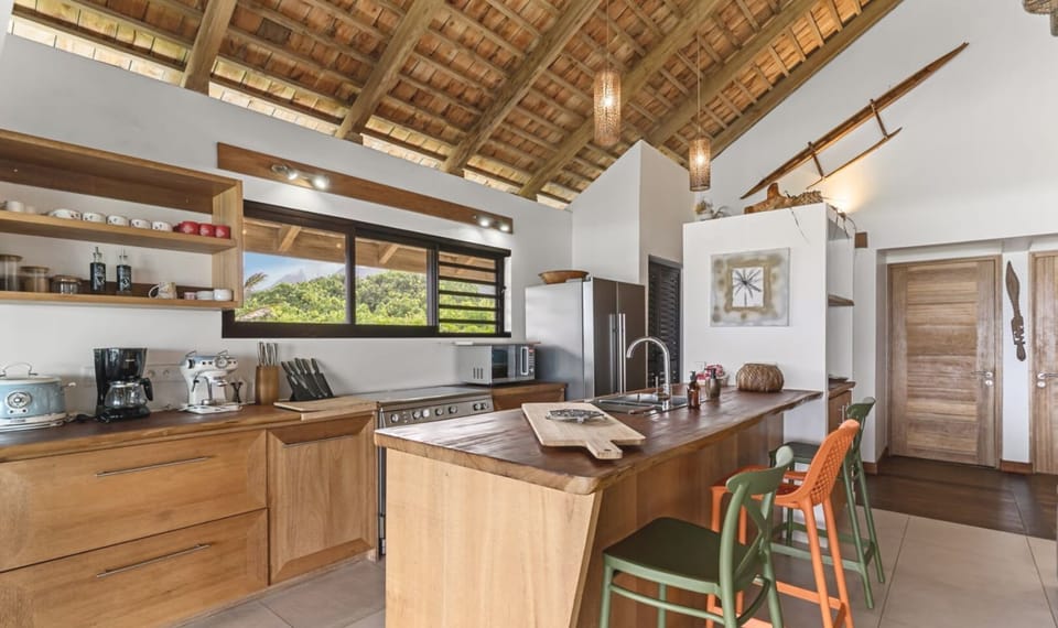 Spacious kitchen with island seating and wooden finishes.