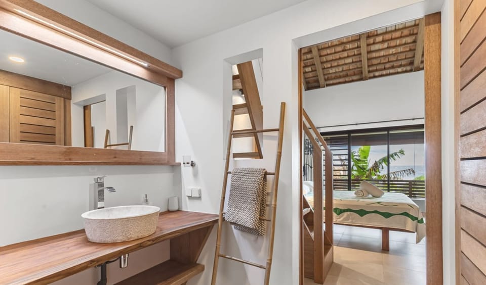 Vanity area with ladder-style towel rack.