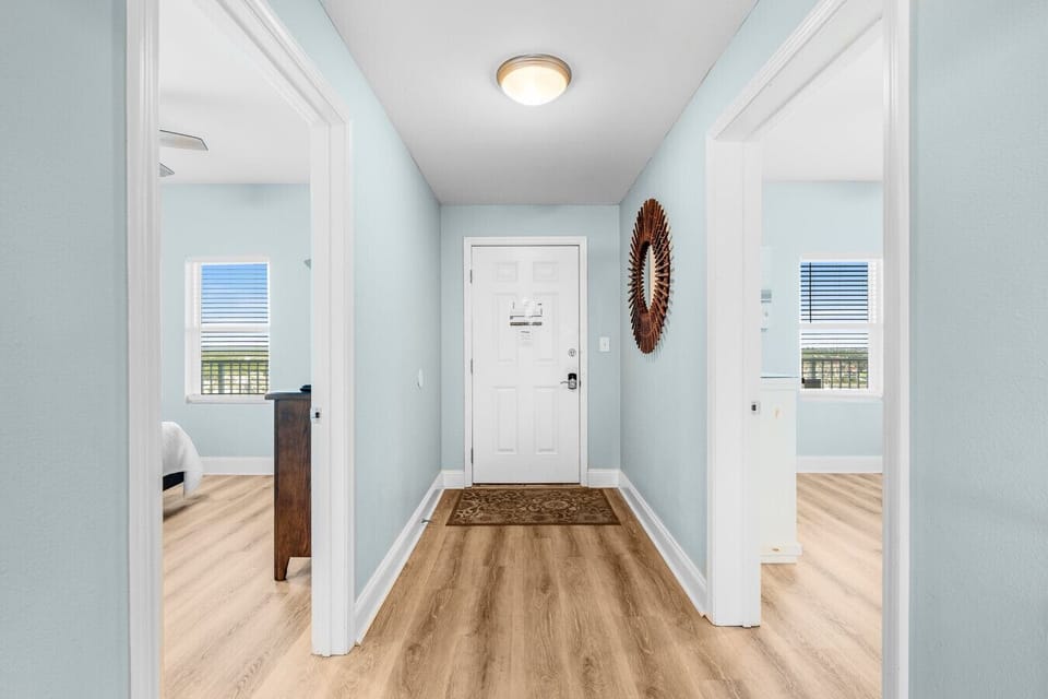 Welcoming entryway with a stylish mirror accent and access to two spacious bedrooms