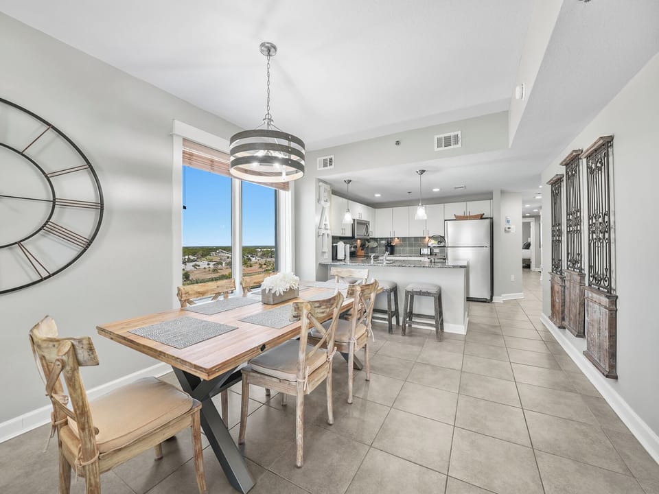 Your open-concept space flows seamlessly from dining to kitchen, with natural light flooding through panoramic windows.