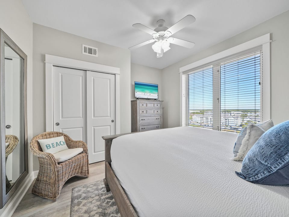 Wake up refreshed in your bright bedroom with a ceiling fan and city views through your private window.